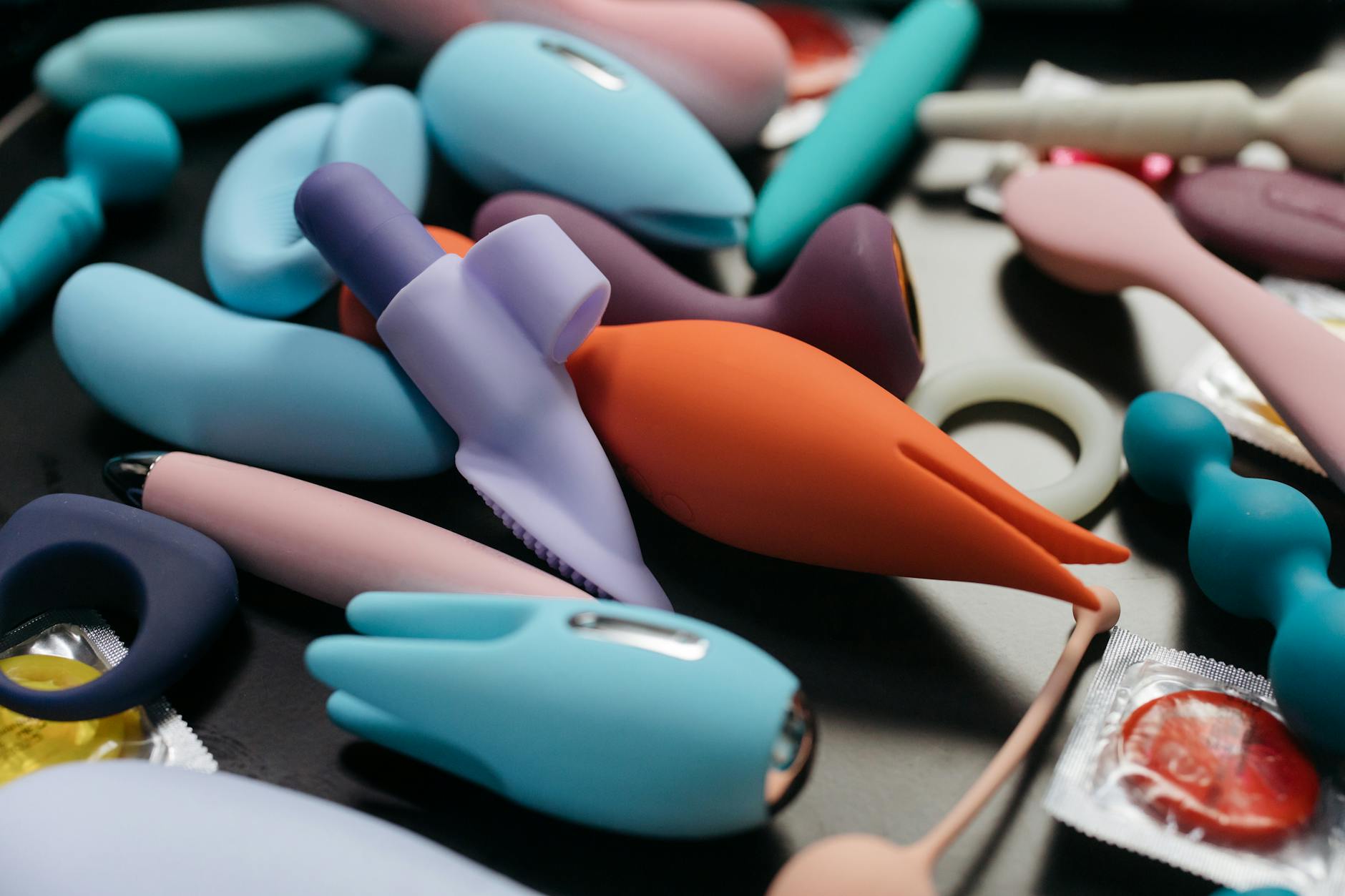 Two hands holding vibrators together, symbolizing shared intimacy and connection between partners.