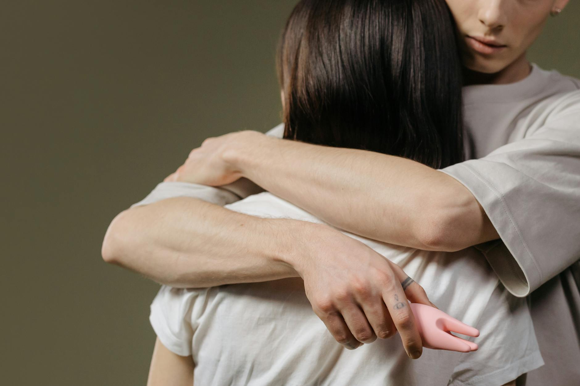 Close-up of a couple embracing in bed, demonstrating intimacy and connection between partners.
